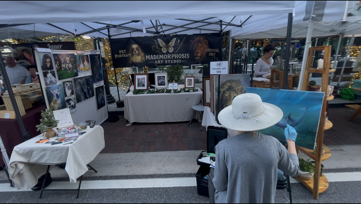 Madison painting at a public art booth
