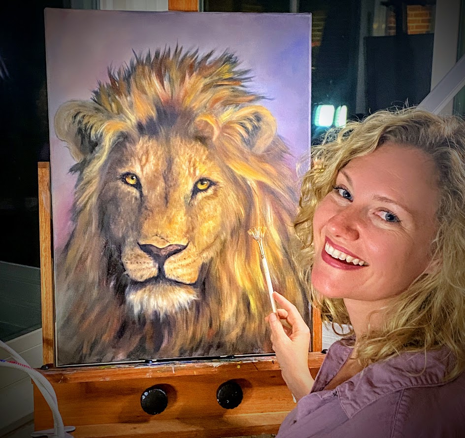 Madison painting a lion at her easel